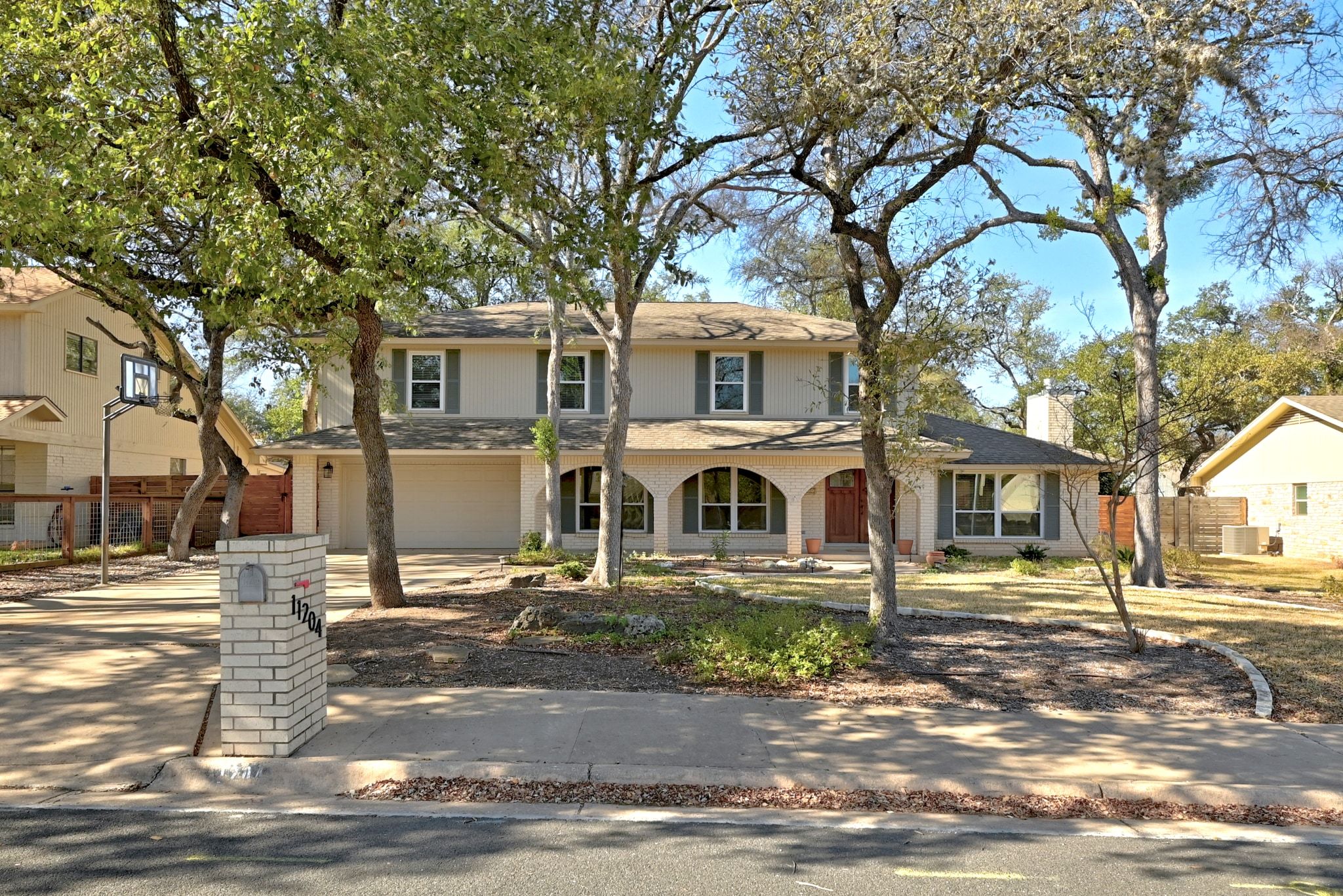 11204 Deadoak Lane Austin, TX 78759 - Photo 2 of 40 a front view of a house with a tree
