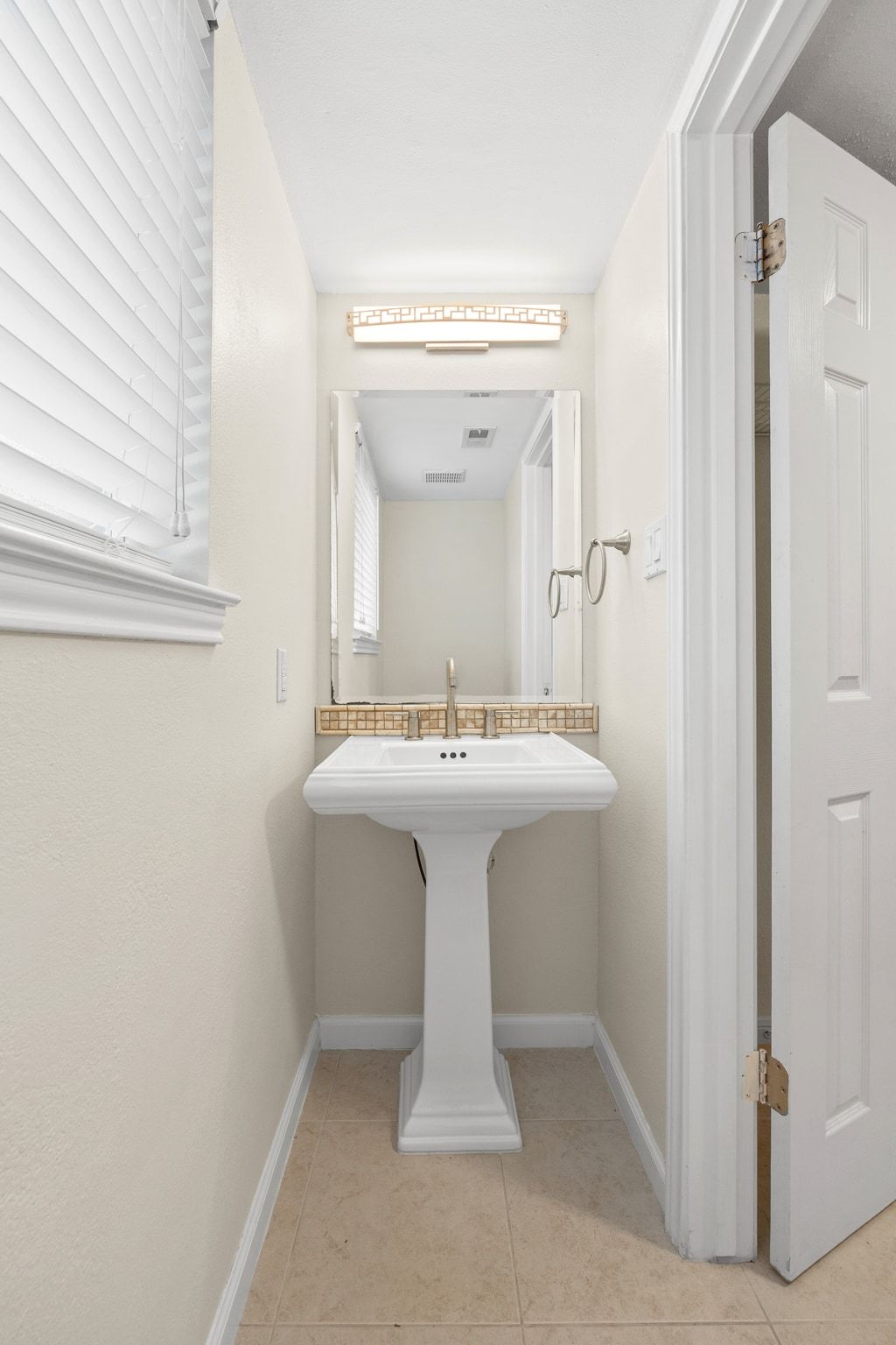 11204 Deadoak Lane Austin, TX 78759 - Photo 22 of 40 a bathroom with a sink mirror and a mirror