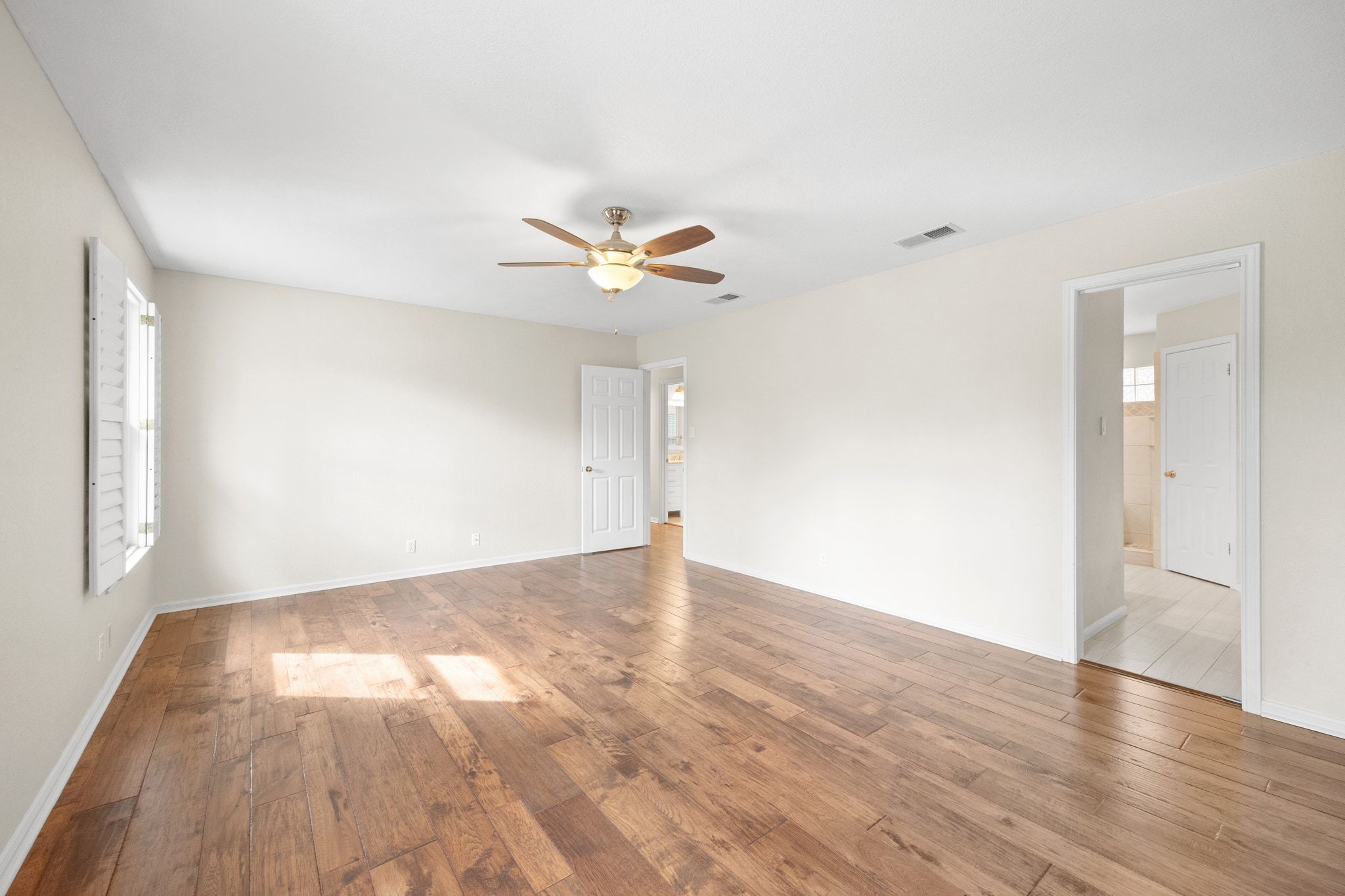 11204 Deadoak Lane Austin, TX 78759 - Photo 24 of 40 wooden floor in an empty room with a window