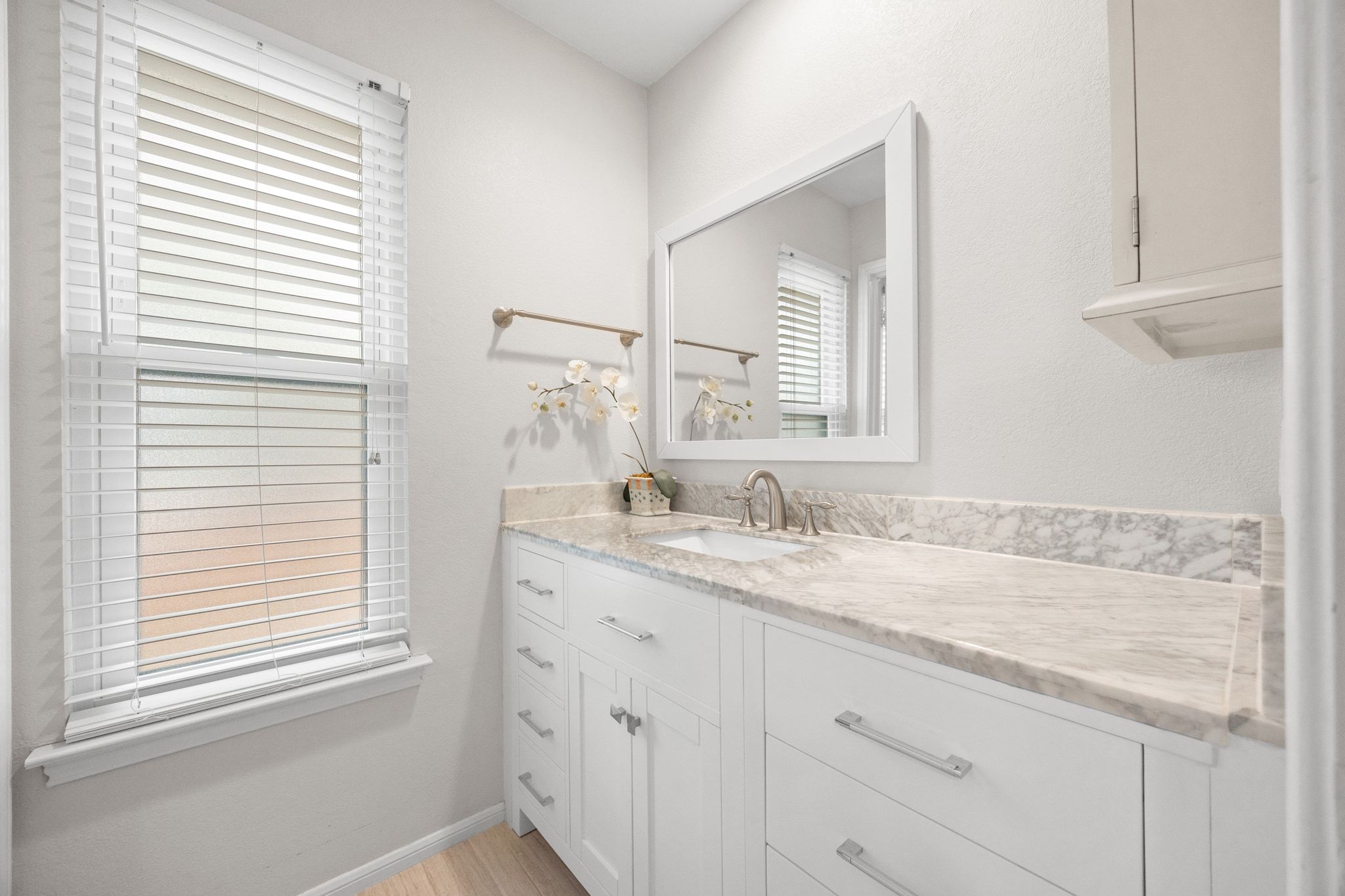 11204 Deadoak Lane Austin, TX 78759 - Photo 31 of 40 a bathroom with a granite countertop sink and a window