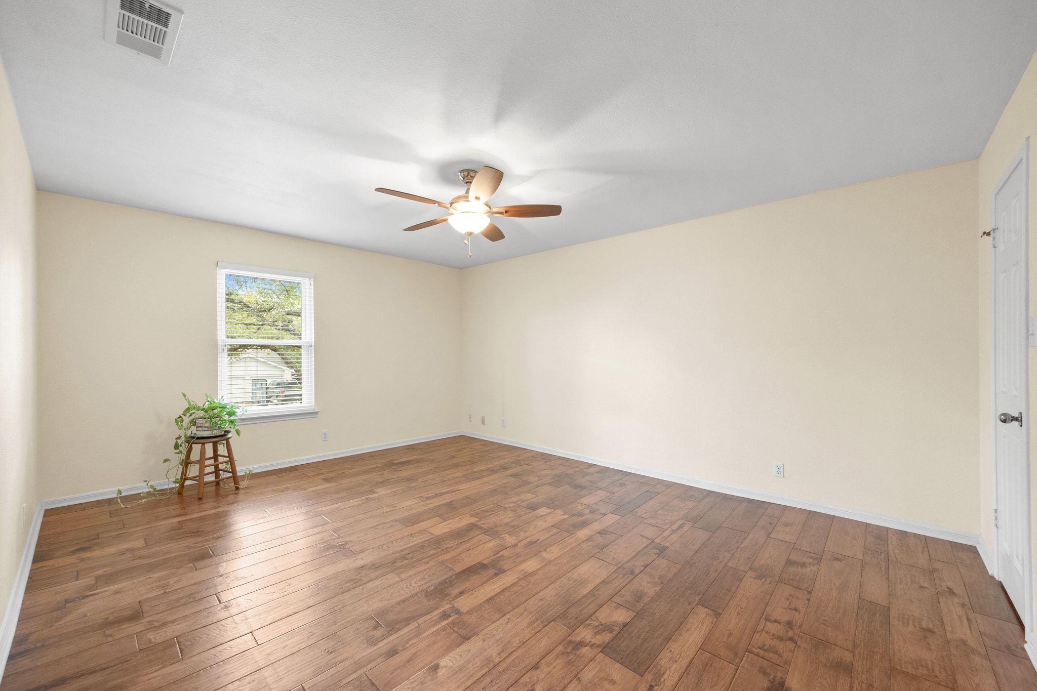 11204 Deadoak Lane Austin, TX 78759 - Photo 34 of 40 an empty room with wooden floor chandelier fan and windows