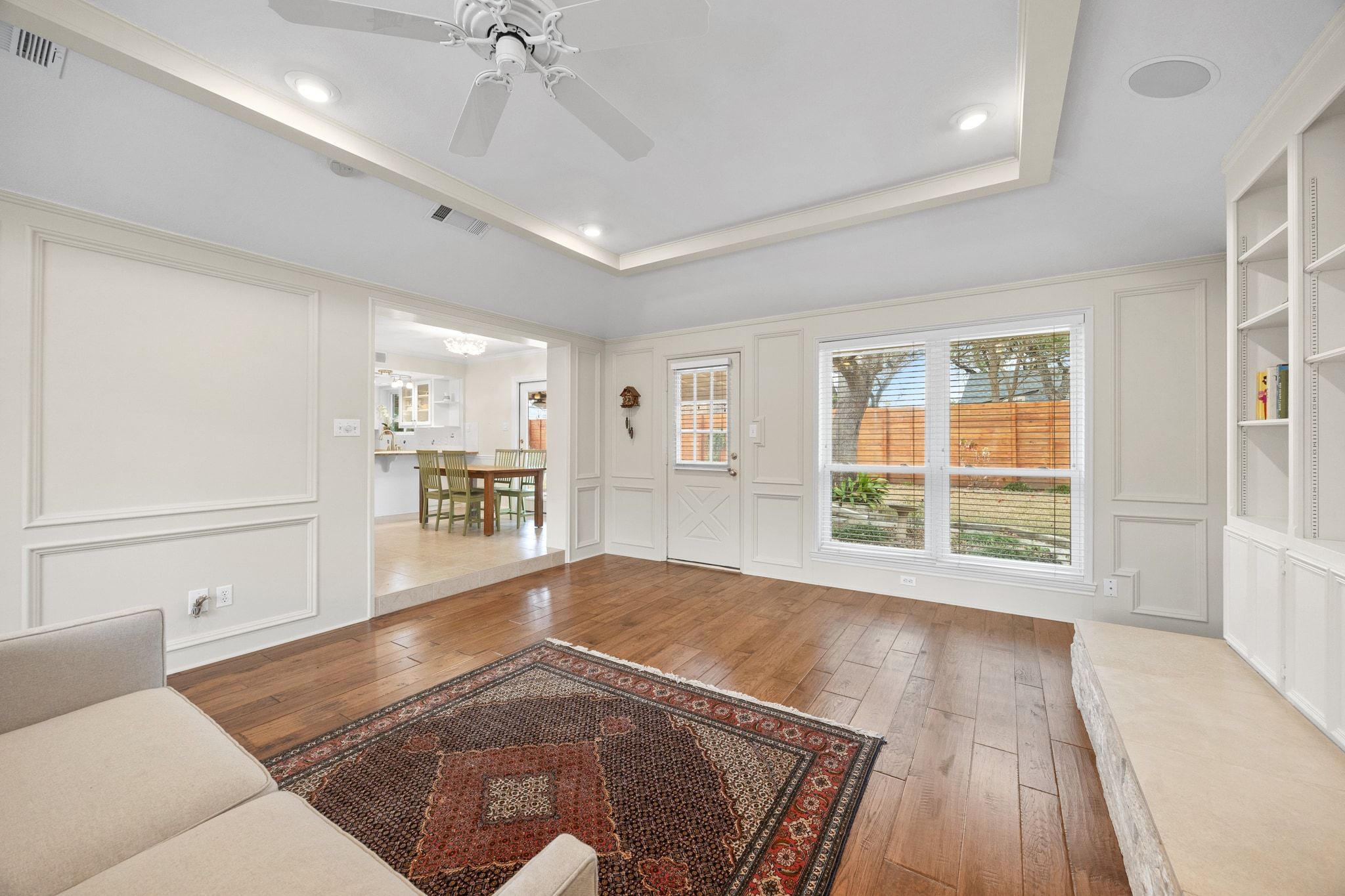 11204 Deadoak Lane Austin, TX 78759 - Photo 10 of 40 a view of a livingroom with wooden floor and a ceiling fan