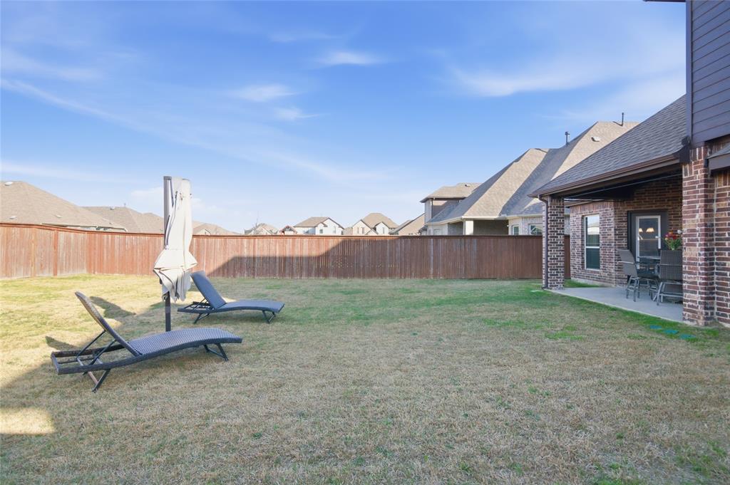 464 LeTara Ranch Drive Haslet, TX 76052 - Photo 34 of 37 Spacious backyard featuring a manicured lawn, full privacy fencing, and an attached covered patio