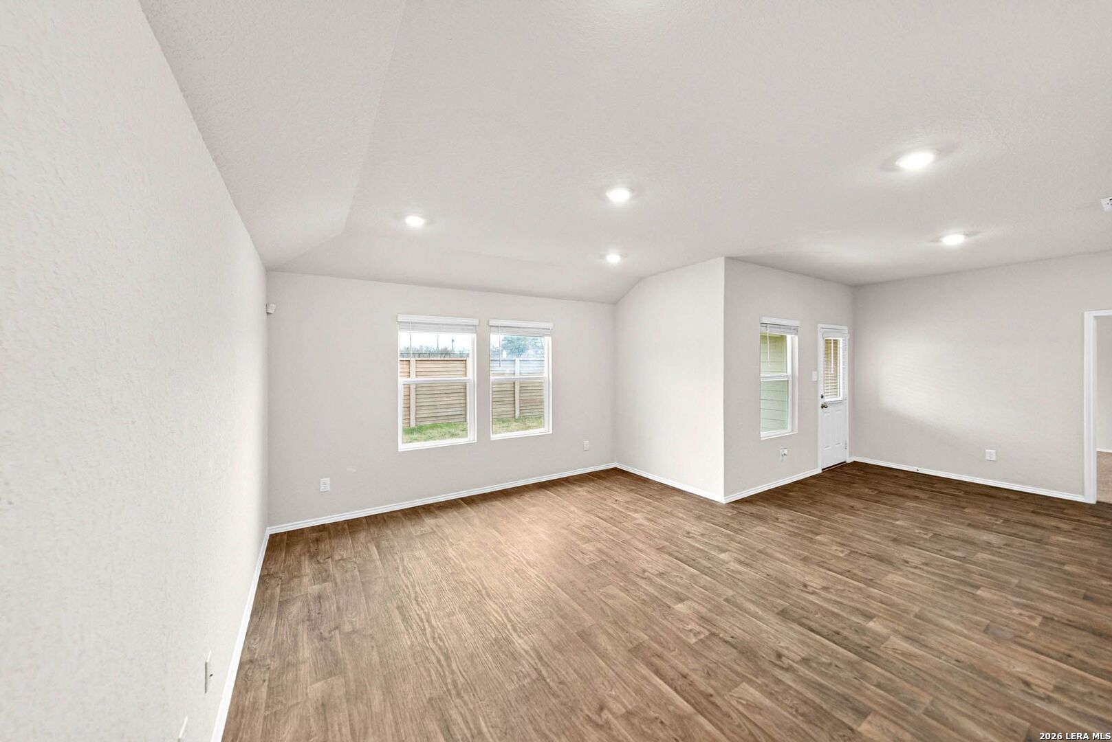 917 Chachalaca Court Seguin, TX 78155 - Photo 8 of 44 an empty room with wooden floor and windows
