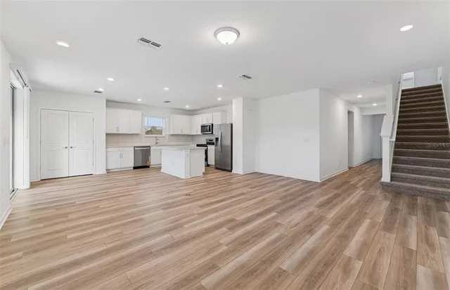 a view of a kitchen with a sink and a refrigerator
