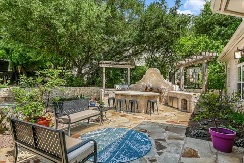 a view of pool with table and chairs under an umbrella
