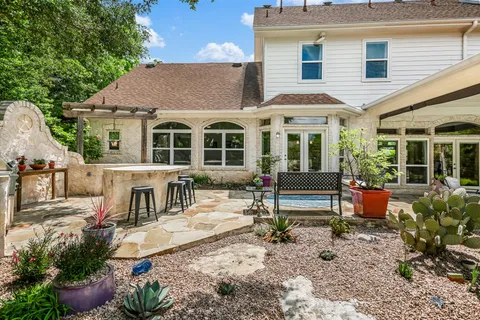 a view of a backyard with swimming pool