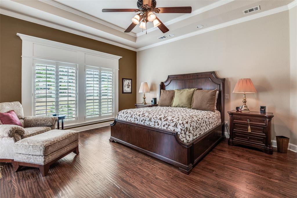 4041 Blackchamp Road Midlothian, TX 76065 - Photo 13 of 34 This primary suite features hand scraped hardwoods, custom plantation shutters and window trim, crown molding, door to patio.