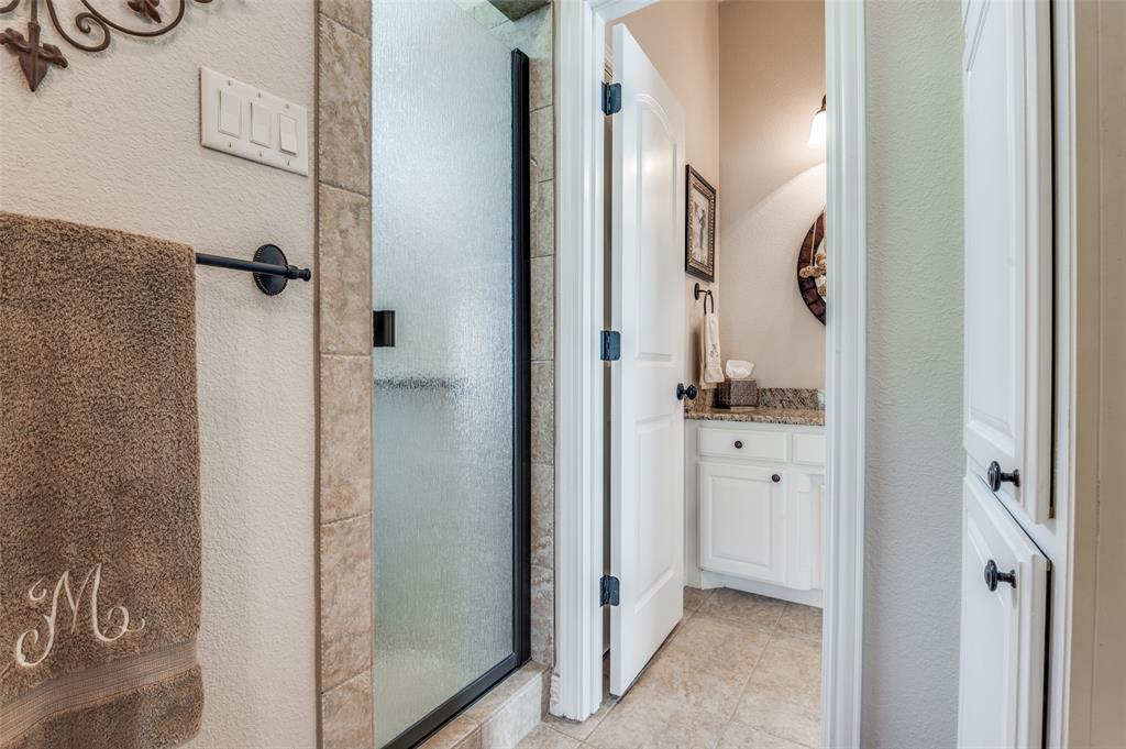 4041 Blackchamp Road Midlothian, TX 76065 - Photo 23 of 34 This bathroom features a large walk in shower, linen storage and potty!