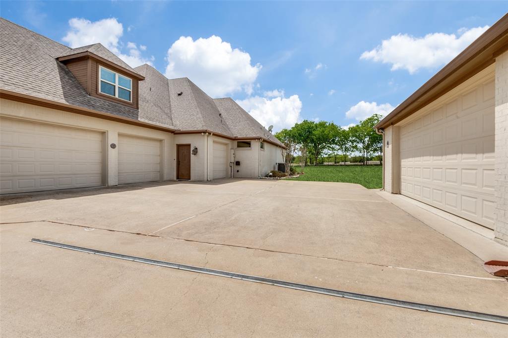 4041 Blackchamp Road Midlothian, TX 76065 - Photo 27 of 34 Garage storage for days! Two car attached offers big workshop, pass through door, large storage closet, built in cabinets. Two car detached is oversized and allows for a lot of storage as well as parking 2 cars! This area is behind an electric gate providing extra security!