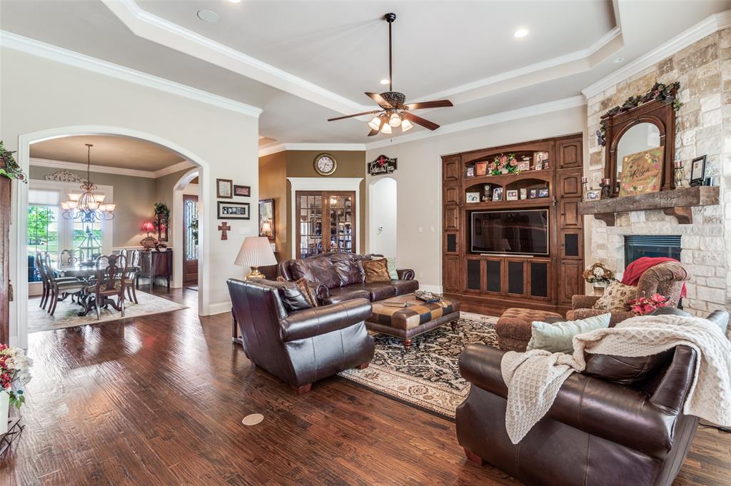 4041 Blackchamp Road Midlothian, TX 76065 - Photo 3 of 34 Hand scraped hardwoods, spacious dining, custom front door, closed private office, stone fireplace, built ins, floor plugs and custom trim work!