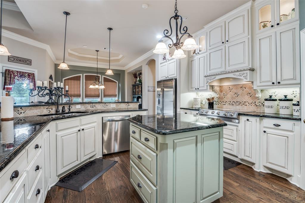 4041 Blackchamp Road Midlothian, TX 76065 - Photo 6 of 34 Amazing chefs kitchen, island, showcase cabinets with lights around the top. Granite tops, appliance garage, over sized walk in pantry, double ovens, built in microwave.