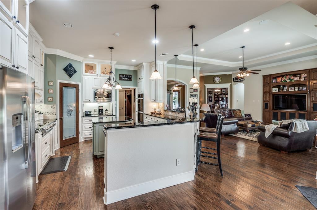4041 Blackchamp Road Midlothian, TX 76065 - Photo 8 of 34 Open to living and breakfast room. Breakfast bar, pendant lighting, recessed lighting, wide baseboards!