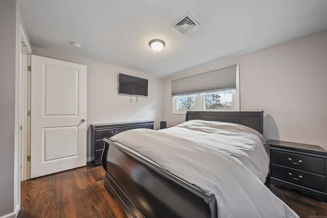 a bedroom with a bed and a tv