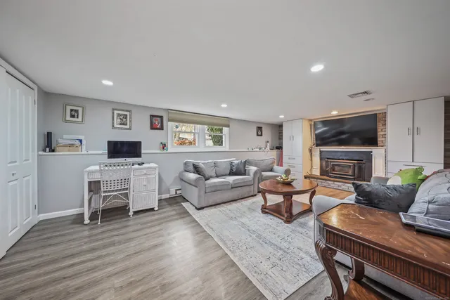 a living room with furniture flat screen tv and a fireplace