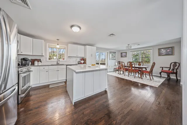 a kitchen with white cabinets and white appliances