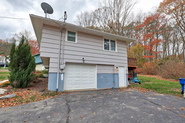 a front view of house with yard and trees around