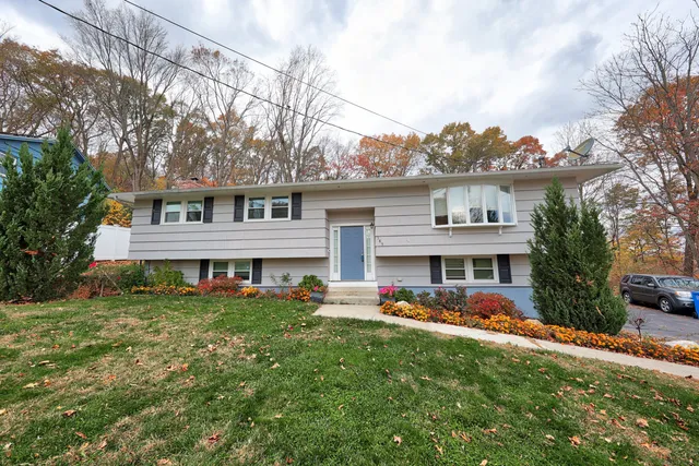 a view of a house with a backyard and a patio