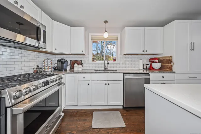 a kitchen with a sink stove and cabinets