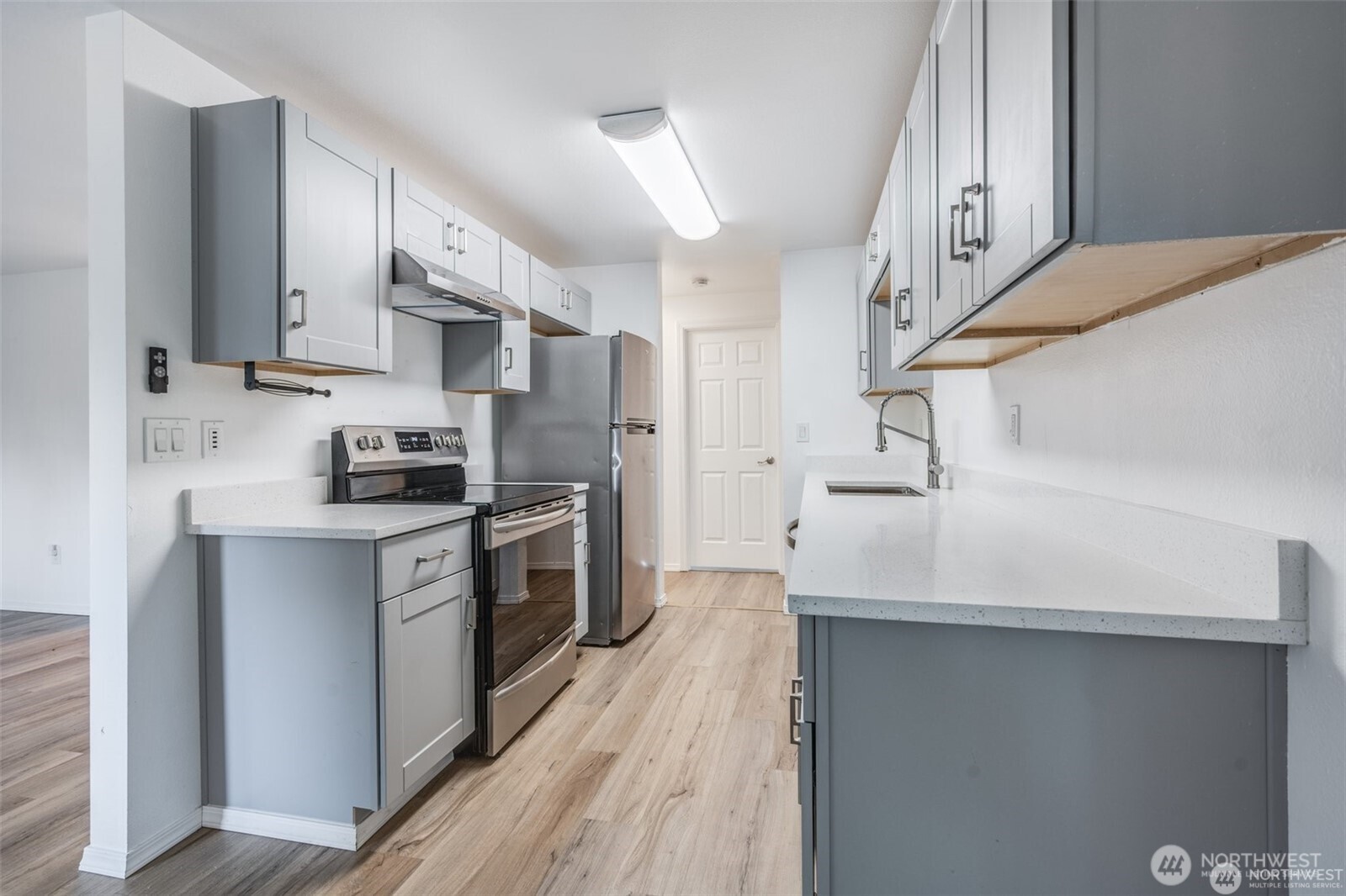 105 96th Street East Tacoma, WA 98445 - Photo 22 of 40 a kitchen with cabinets and stainless steel appliances