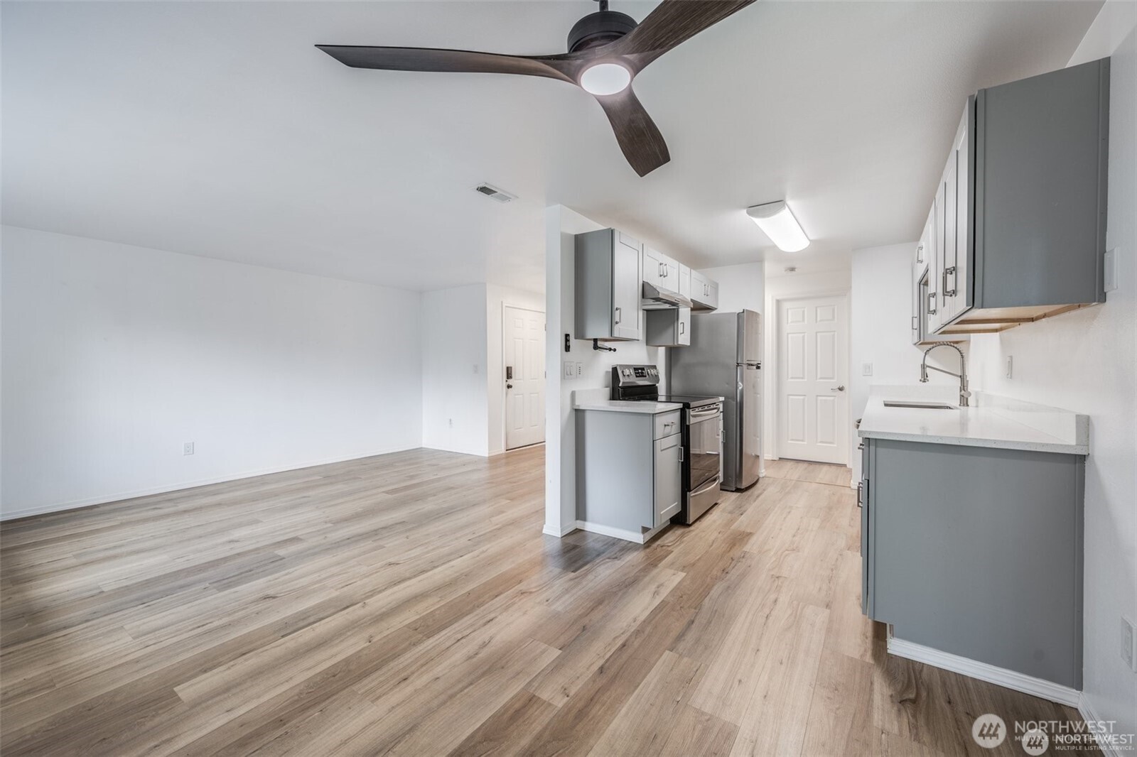 105 96th Street East Tacoma, WA 98445 - Photo 29 of 40 a kitchen with stainless steel appliances a refrigerator and a sink