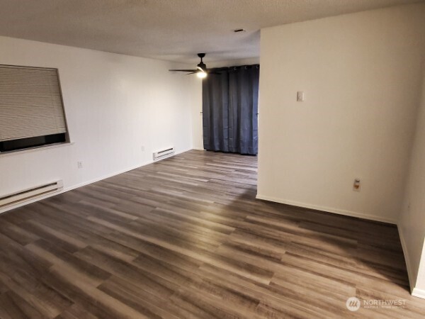 105 96th Street East Tacoma, WA 98445 - Photo 38 of 40 a view of an empty room with wooden floor