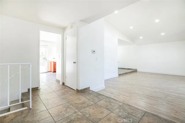 a large kitchen with stainless steel appliances granite countertop a stove refrigerator and cabinets