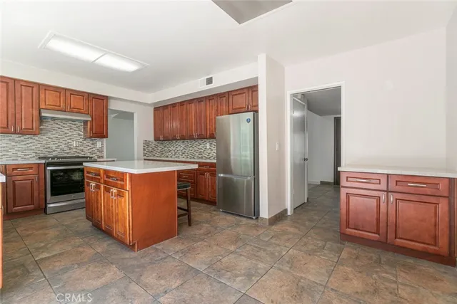 an empty room with wooden floor and fireplace