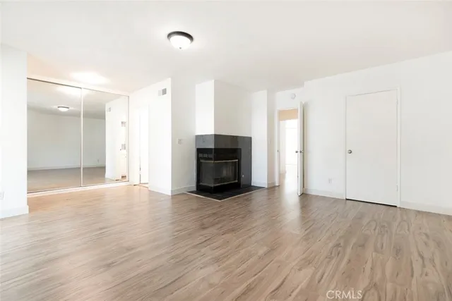 a bathroom with a granite countertop toilet sink and mirror
