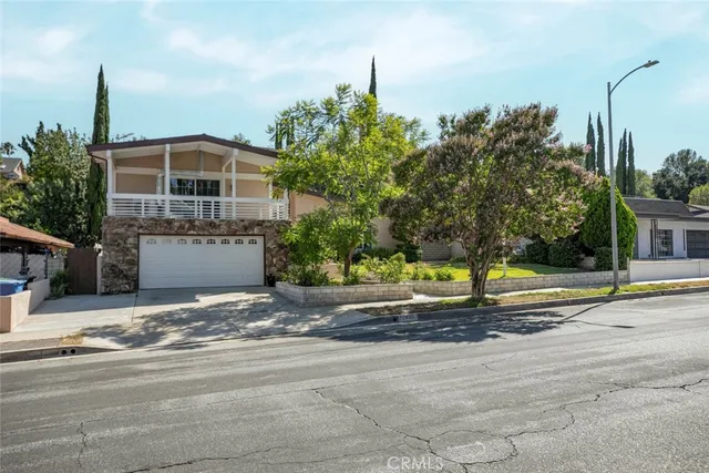 a view of a balcony with lots of potted plants