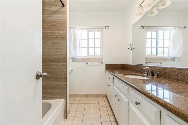 a view of a porch with furniture and a garden
