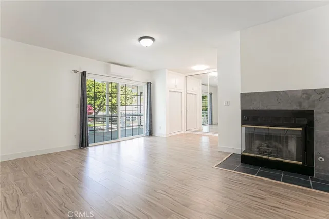 a view of a house with a small yard and wooden floor and fence