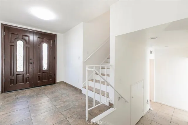 an empty room with wooden floor and window