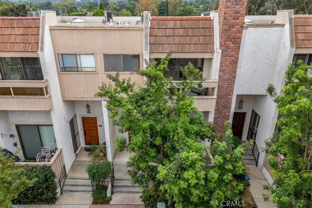 an aerial view of a house with a yard and plants