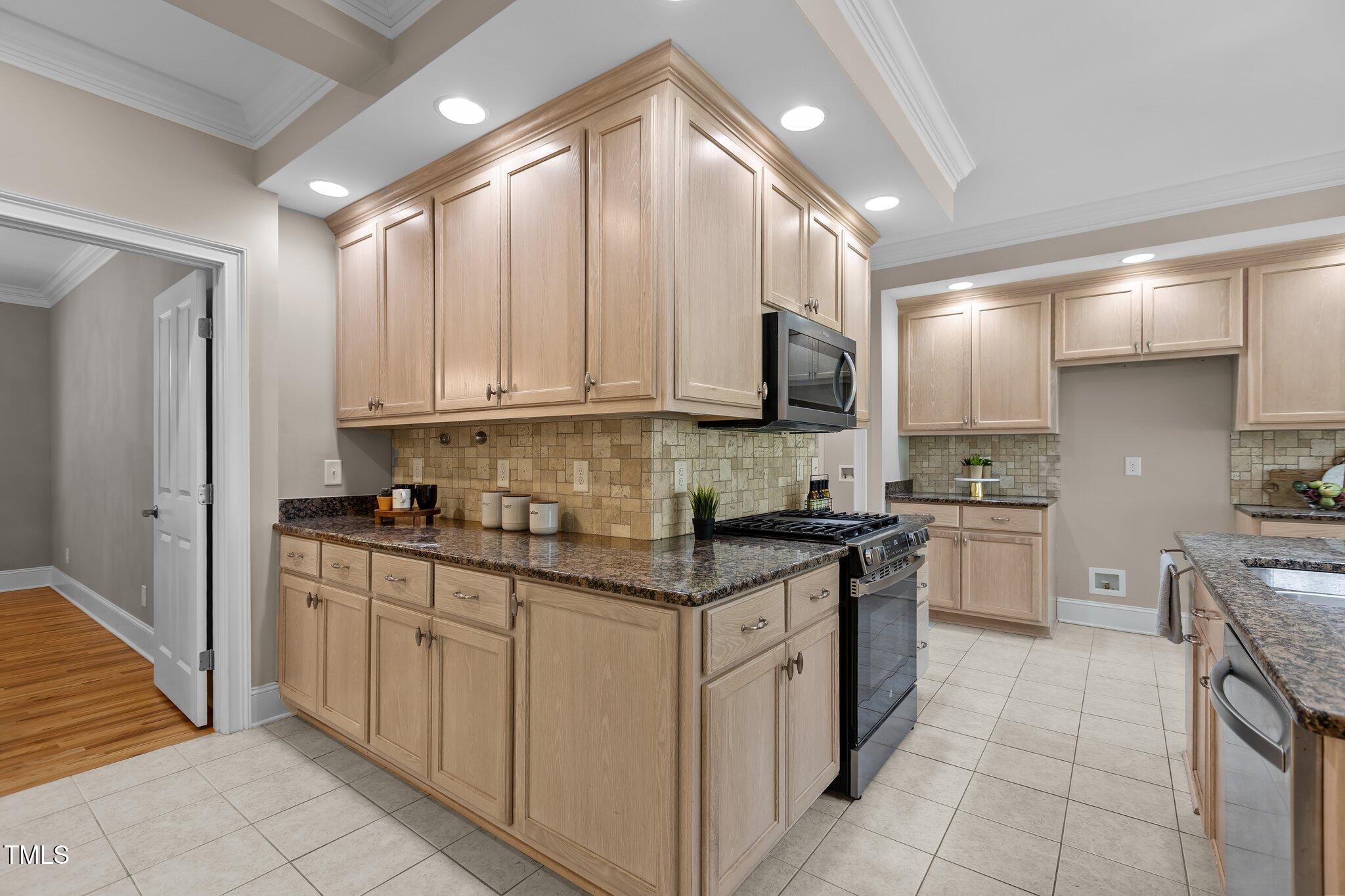 3600 Trail 23 Durham, NC 27707 - Photo 13 of 68 a kitchen with stainless steel appliances granite countertop a stove sink and cabinets