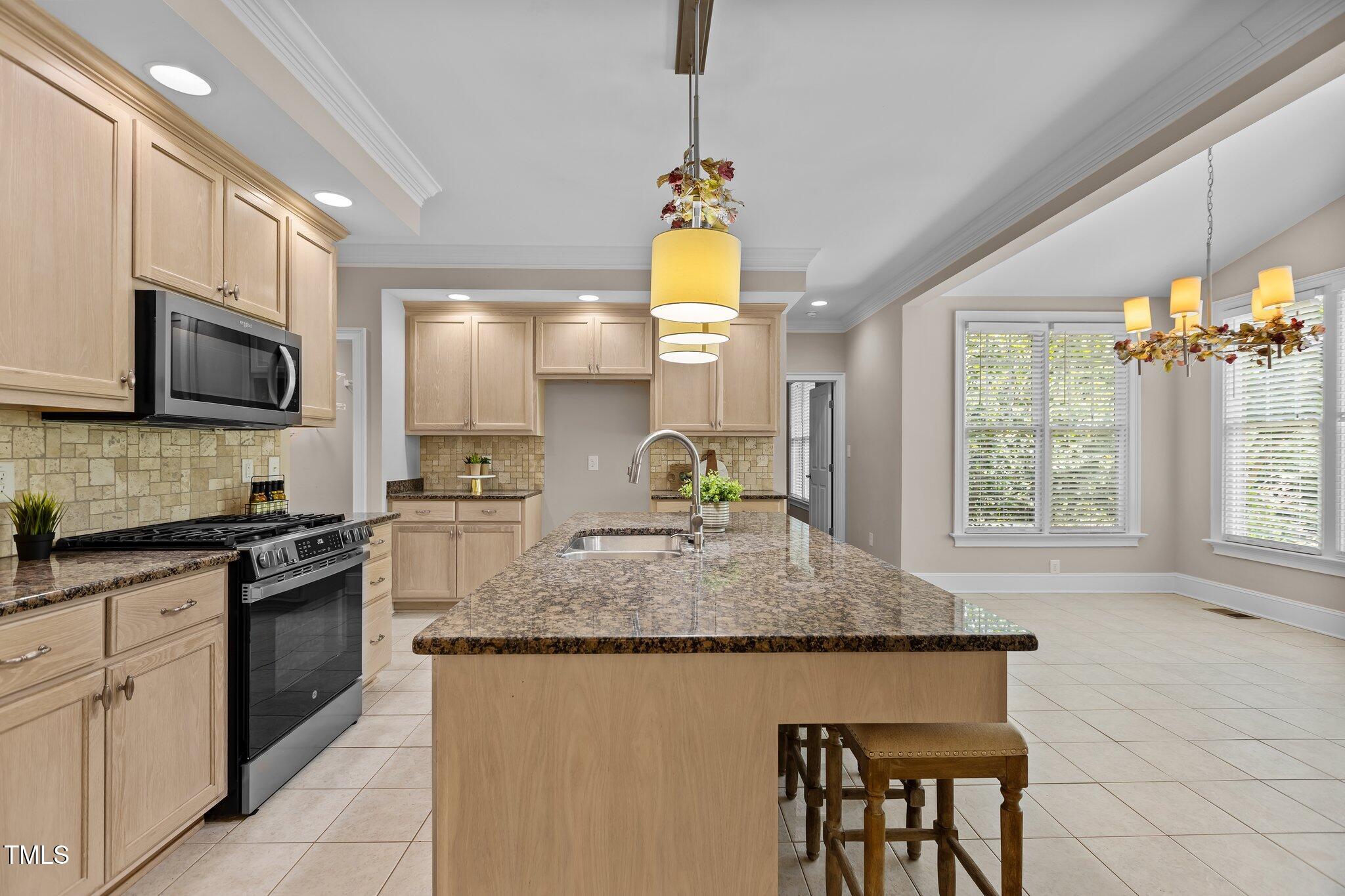 3600 Trail 23 Durham, NC 27707 - Photo 14 of 68 a kitchen with kitchen island granite countertop a stove a sink a oven and a dining table with wooden floor