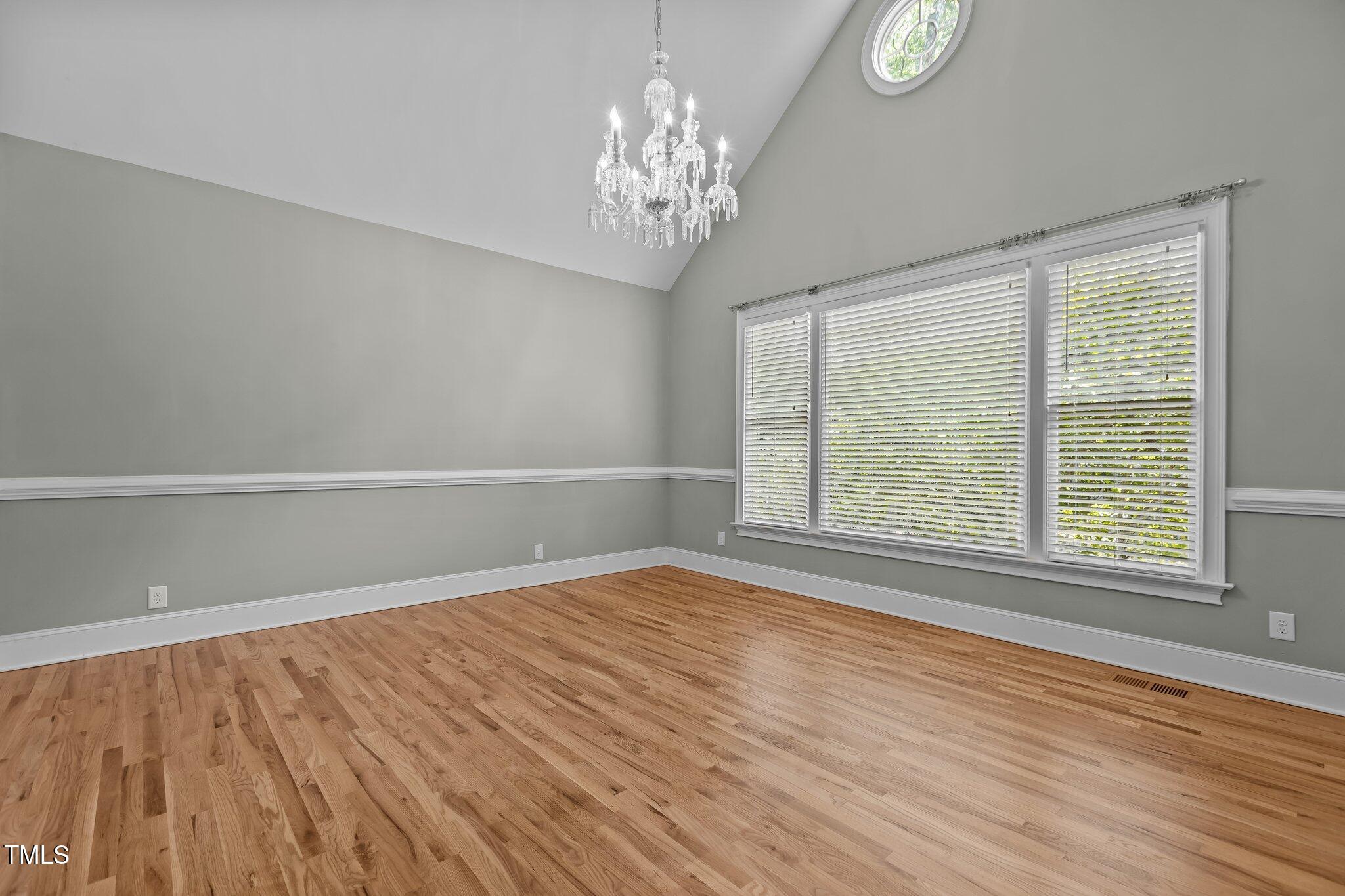 3600 Trail 23 Durham, NC 27707 - Photo 3 of 68 a view of an empty room with wooden floor and a window
