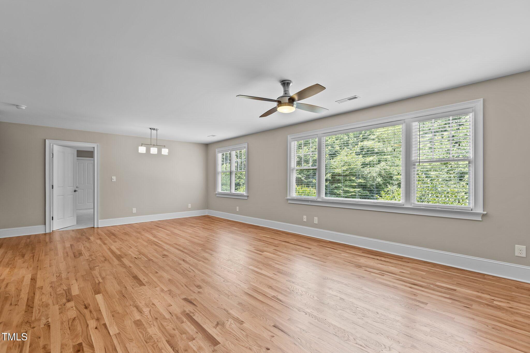 3600 Trail 23 Durham, NC 27707 - Photo 32 of 68 a view of empty room with wooden floor and fan
