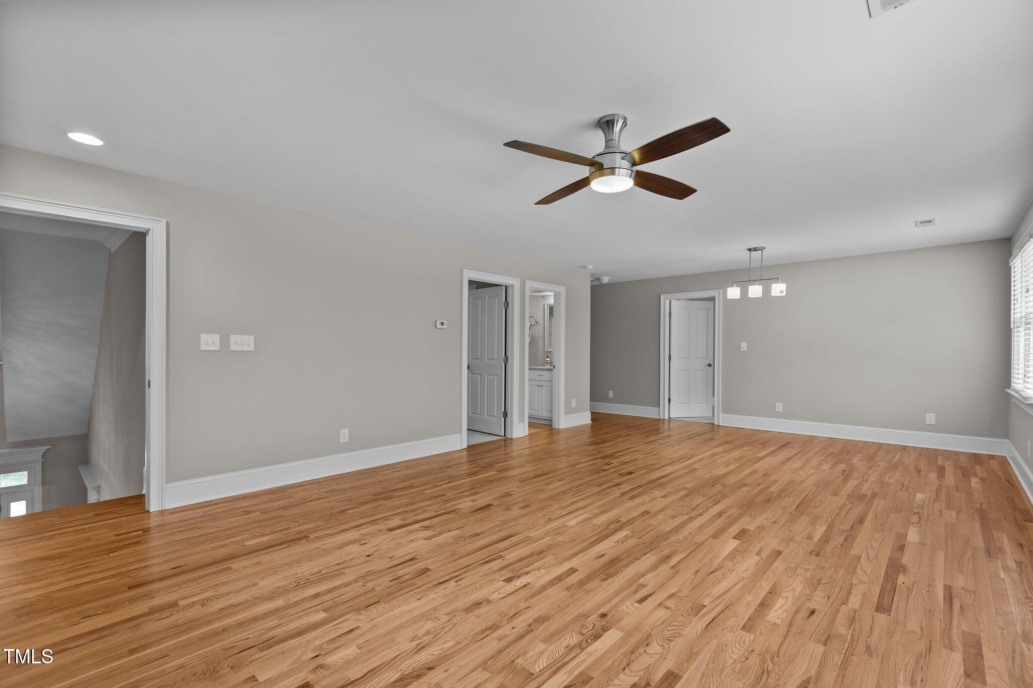3600 Trail 23 Durham, NC 27707 - Photo 33 of 68 a view of empty room with wooden floor and ceiling fan