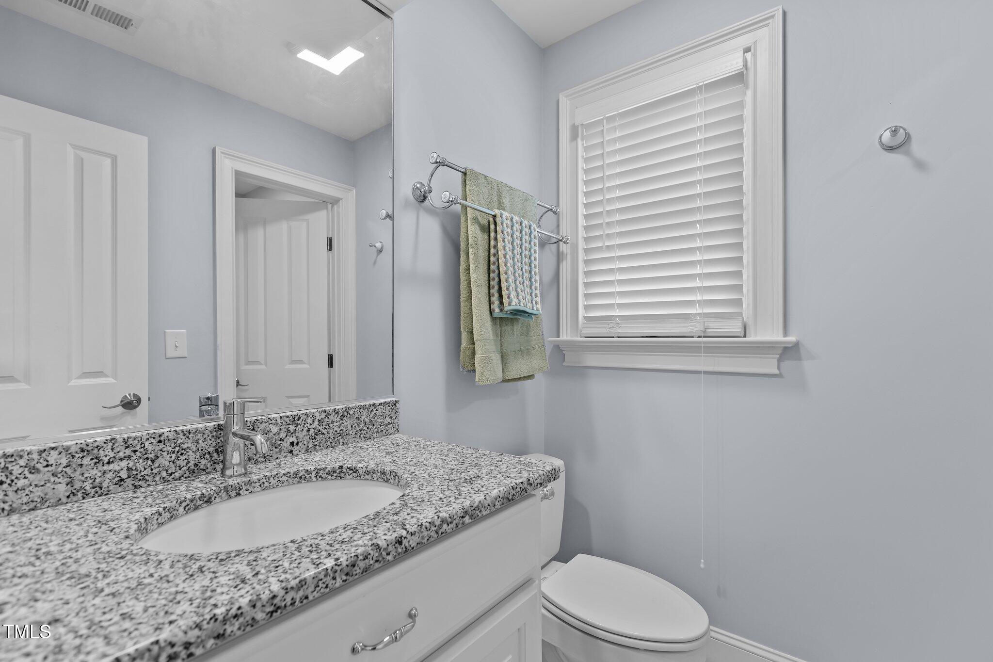 3600 Trail 23 Durham, NC 27707 - Photo 39 of 68 a bathroom with a granite countertop toilet sink and mirror