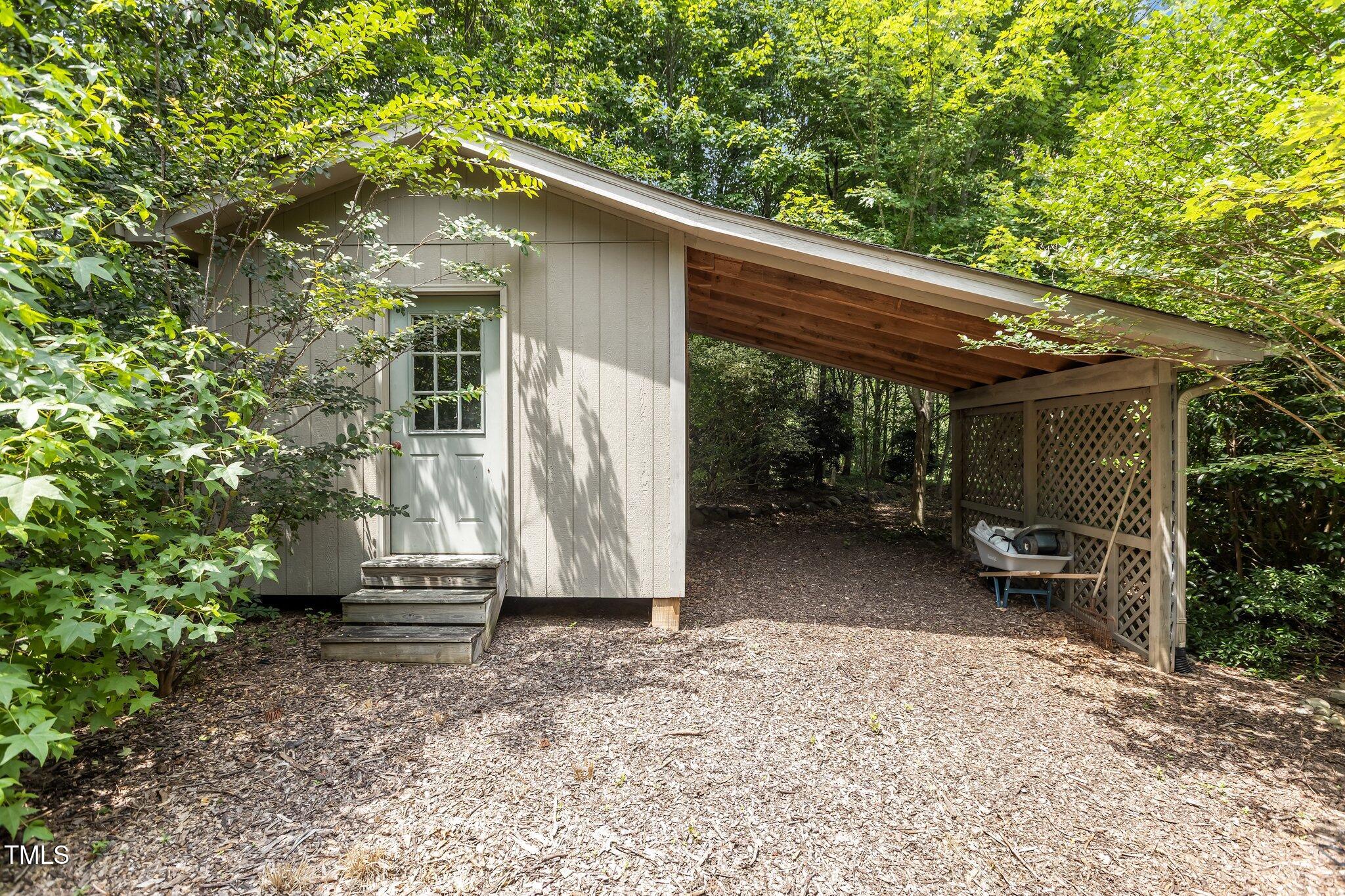 3600 Trail 23 Durham, NC 27707 - Photo 55 of 68 a view of a patio with table and chairs with wooden fence and plants