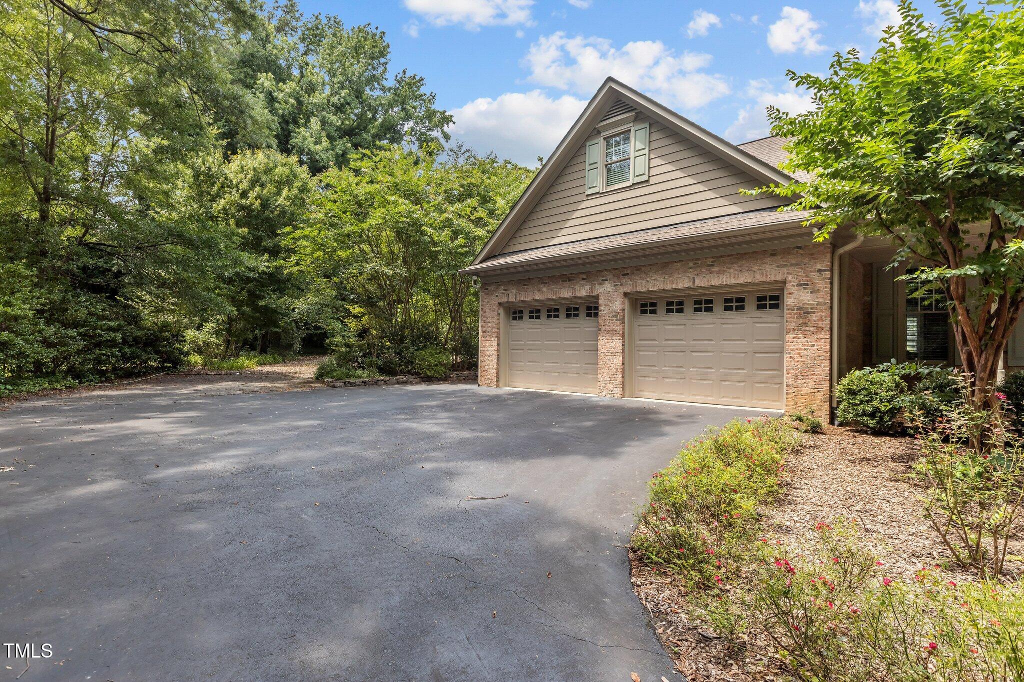 3600 Trail 23 Durham, NC 27707 - Photo 59 of 68 a front view of a house with a yard and garage