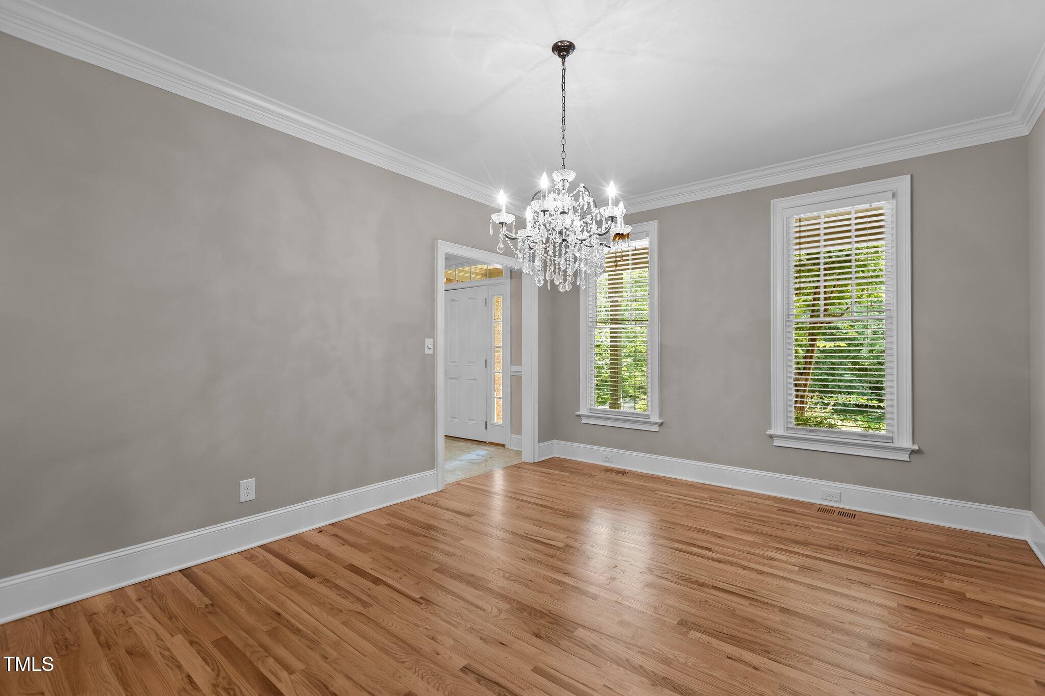3600 Trail 23 Durham, NC 27707 - Photo 7 of 68 a view of an empty room with wooden floor and a window