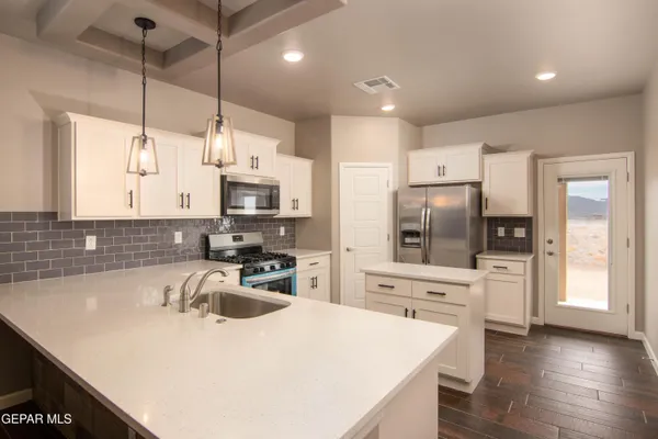 a kitchen with a sink stove and microwave
