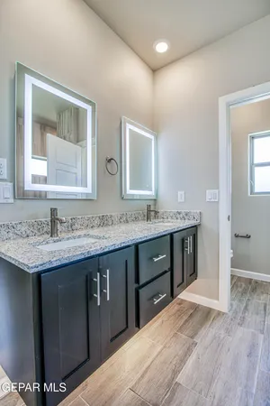 a bathroom with a double vanity sink and mirror