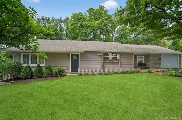 a front view of a house with a garden