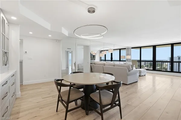 a view of a dining room with furniture and a large window
