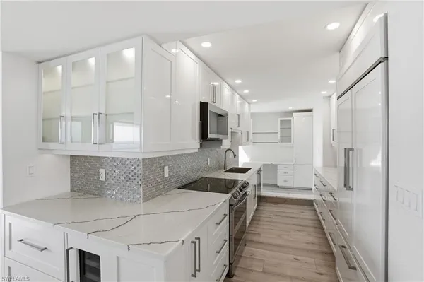 a kitchen with a sink a stove and cabinets