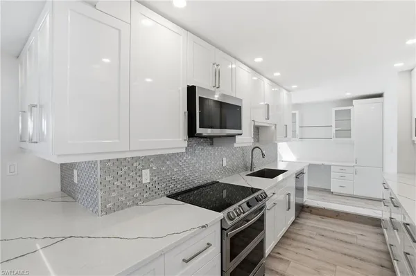 a kitchen that has a sink and a stove