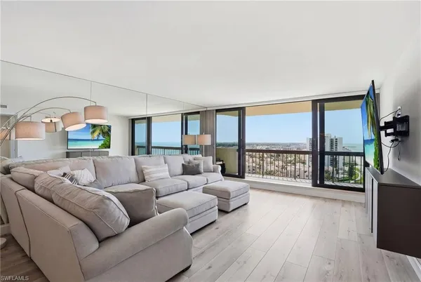 a living room with furniture and a large window